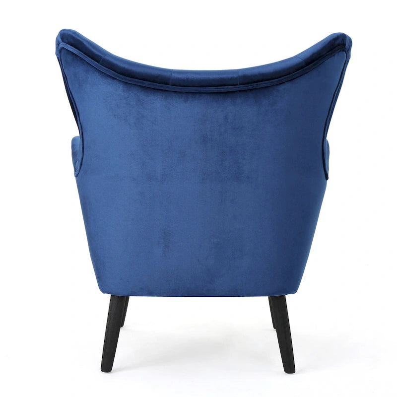 Sillón de terciopelo con respaldo alto y capitoné