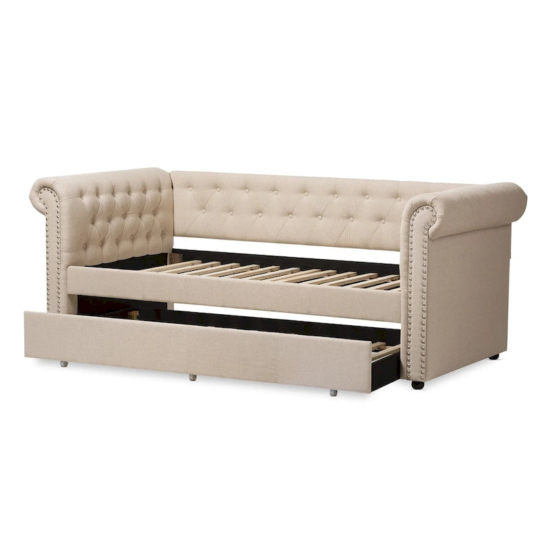 Cama nido tapizada con ribete de tachuelas